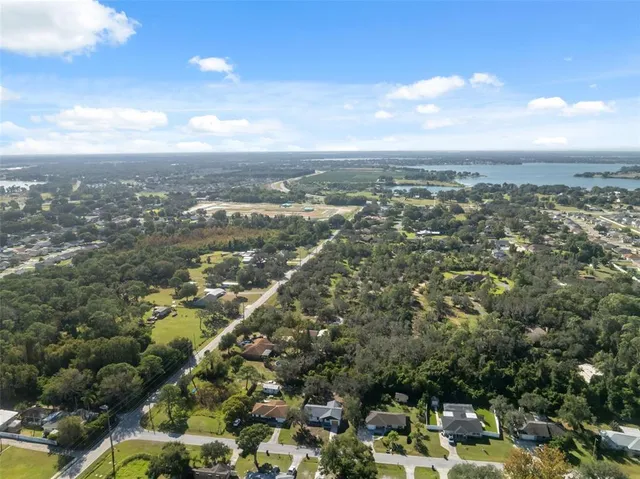 an aerial view of residential building with green space