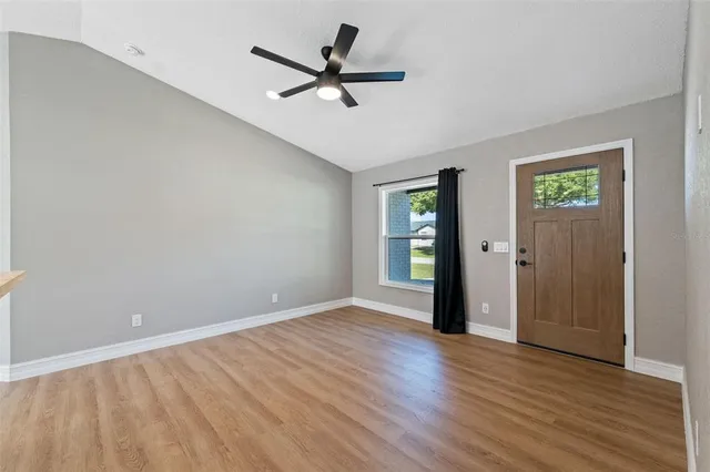wooden floor in an empty room with a window