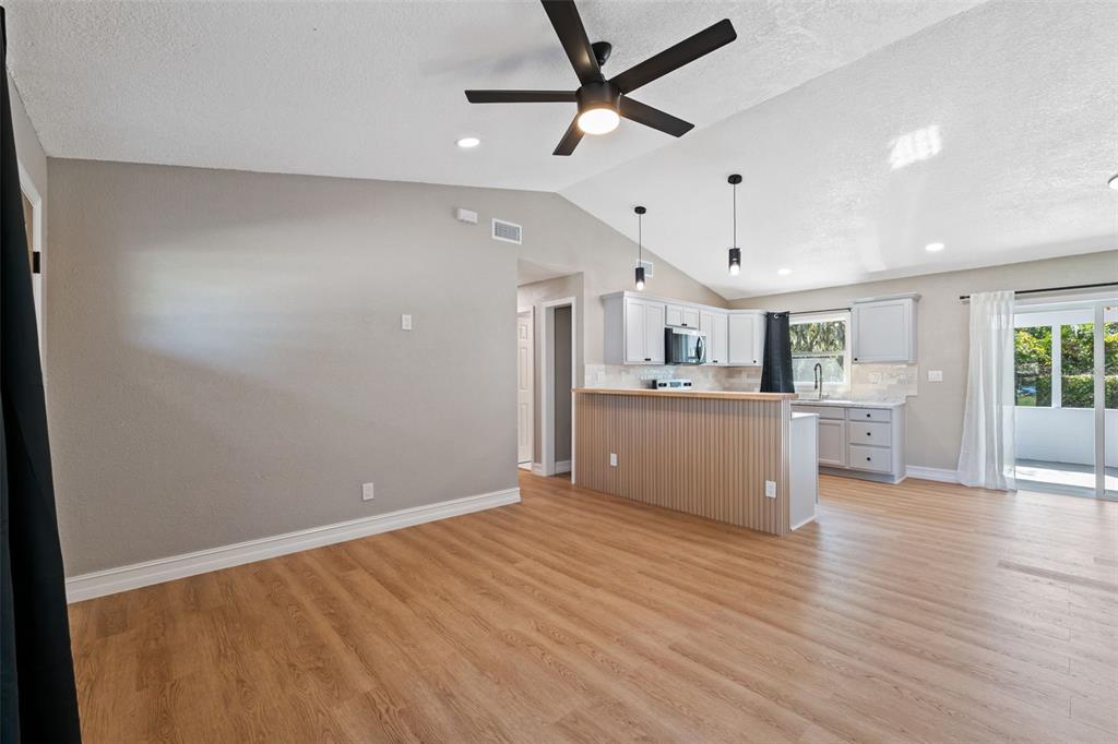 606 Kings Lane Southwest Winter Haven, FL 33880 - Photo 6 of 50 a view of a kitchen with a sink and a refrigerator