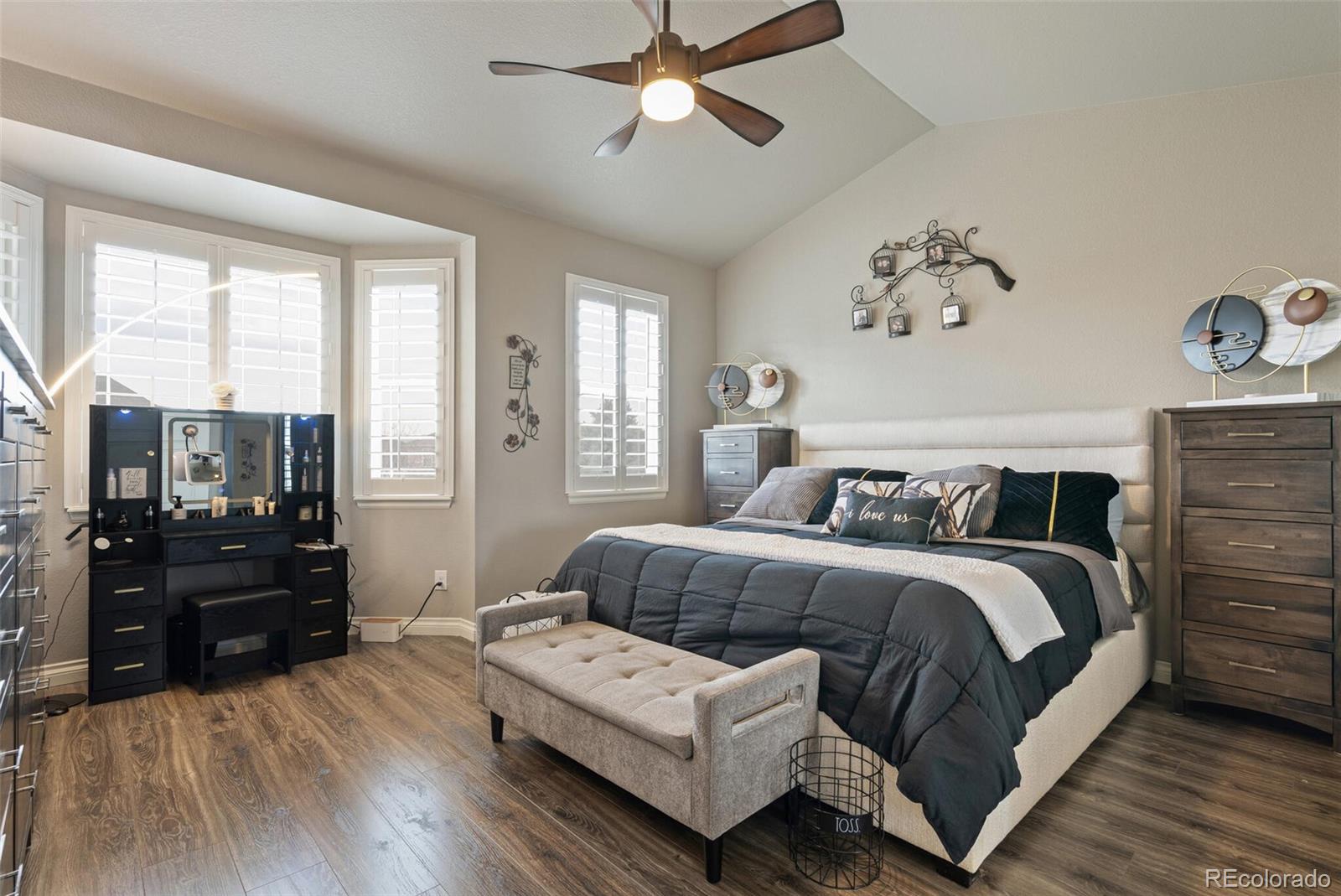 8841 Peakview Avenue Firestone, CO 80504 - Photo 17 of 40 a spacious bedroom with a bed and wooden floor