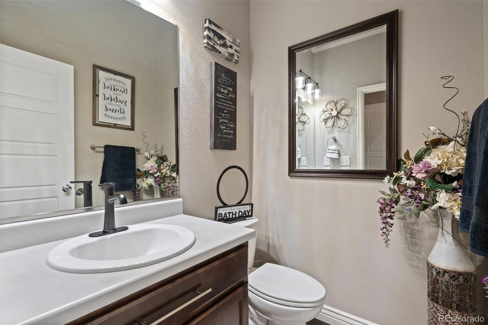 8841 Peakview Avenue Firestone, CO 80504 - Photo 23 of 40 a bathroom with a granite countertop toilet sink and mirror