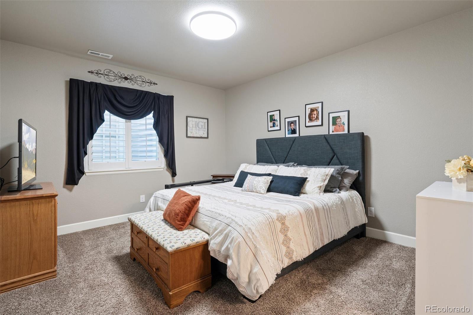 8841 Peakview Avenue Firestone, CO 80504 - Photo 28 of 40 a bedroom with a bed and a flat screen tv
