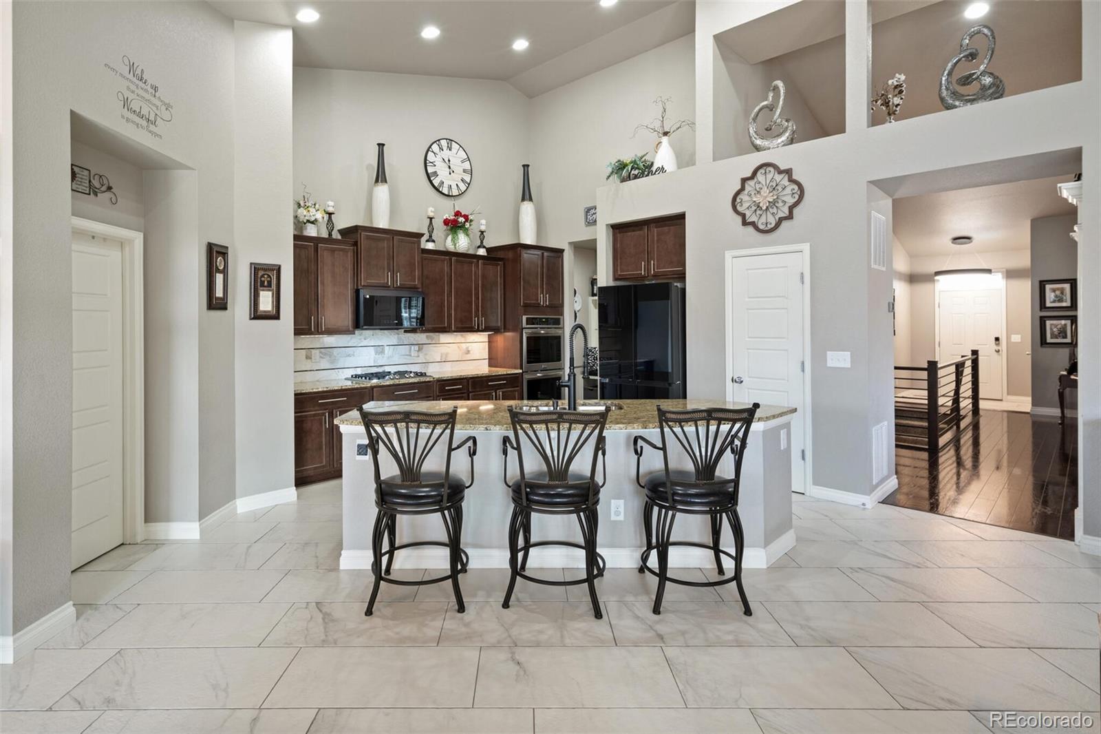 8841 Peakview Avenue Firestone, CO 80504 - Photo 3 of 40 a view of a dining room kitchen with furniture and a clock