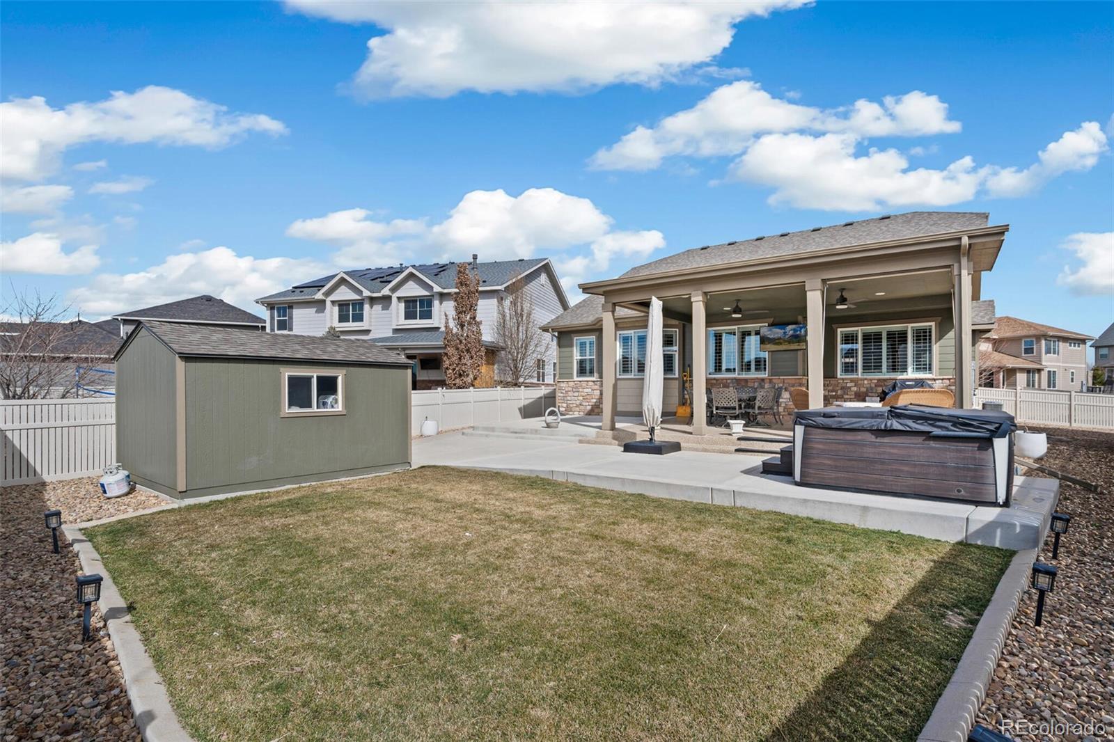 8841 Peakview Avenue Firestone, CO 80504 - Photo 36 of 40 a view of a house with floor to ceiling windows and a rug