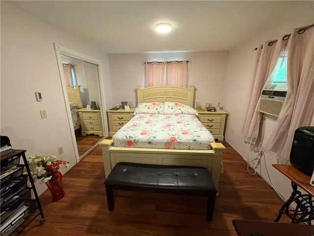 a bed sitting in a room next to a window