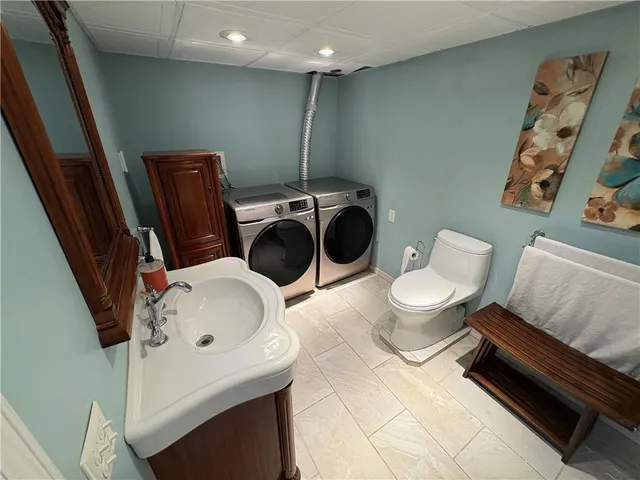 a bathroom with a toilet sink and shower