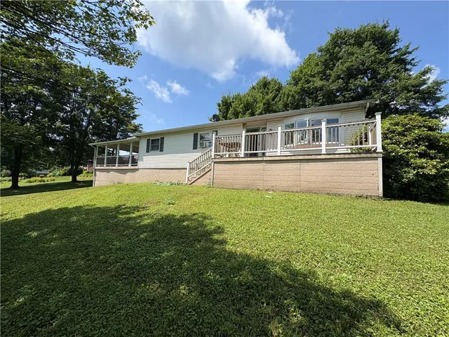 a front view of house with yard and green space