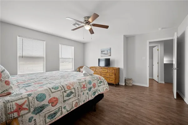 a bathroom with a granite countertop sink a toilet and a mirror