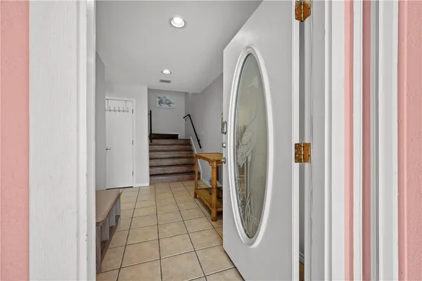 a view of a livingroom with wooden floor and stairs