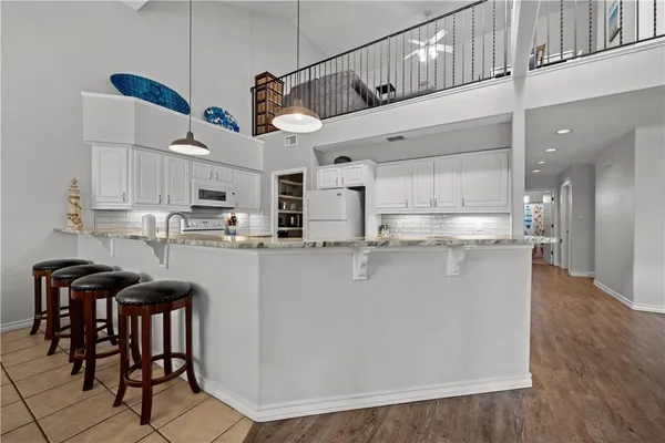 a kitchen with stainless steel appliances granite countertop a sink a stove and cabinets