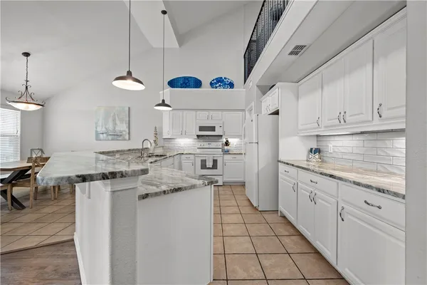 a kitchen with cabinets a sink and appliances