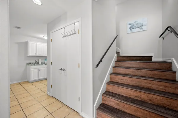 a view of staircase and kitchen with sink