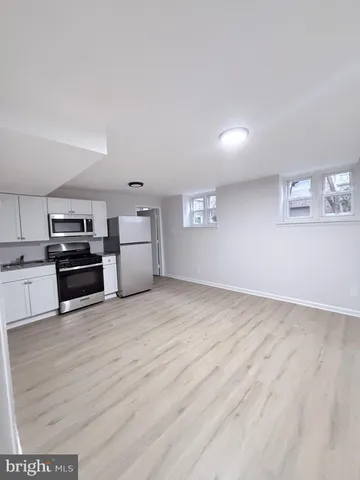 a view of a kitchen with a dishwasher and a stove top oven