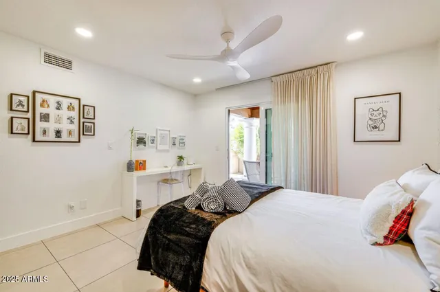 a bedroom with a large bed and a sink