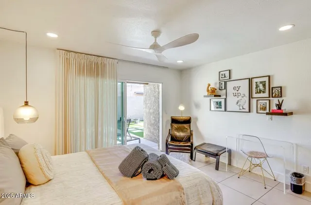 a bedroom with a bed a desk and chair