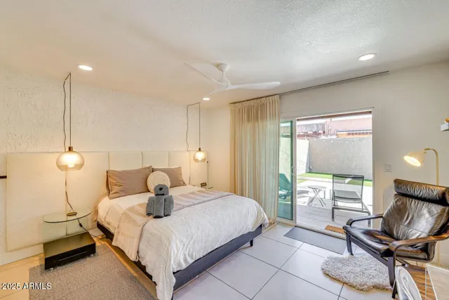 a bedroom with a bed and a painting on the wall