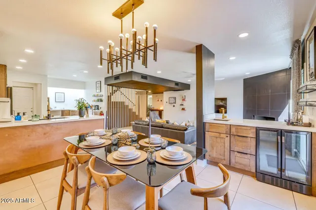 a dining room with furniture and a chandelier
