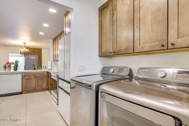 a view of a patio with table and chairs near a barbeque