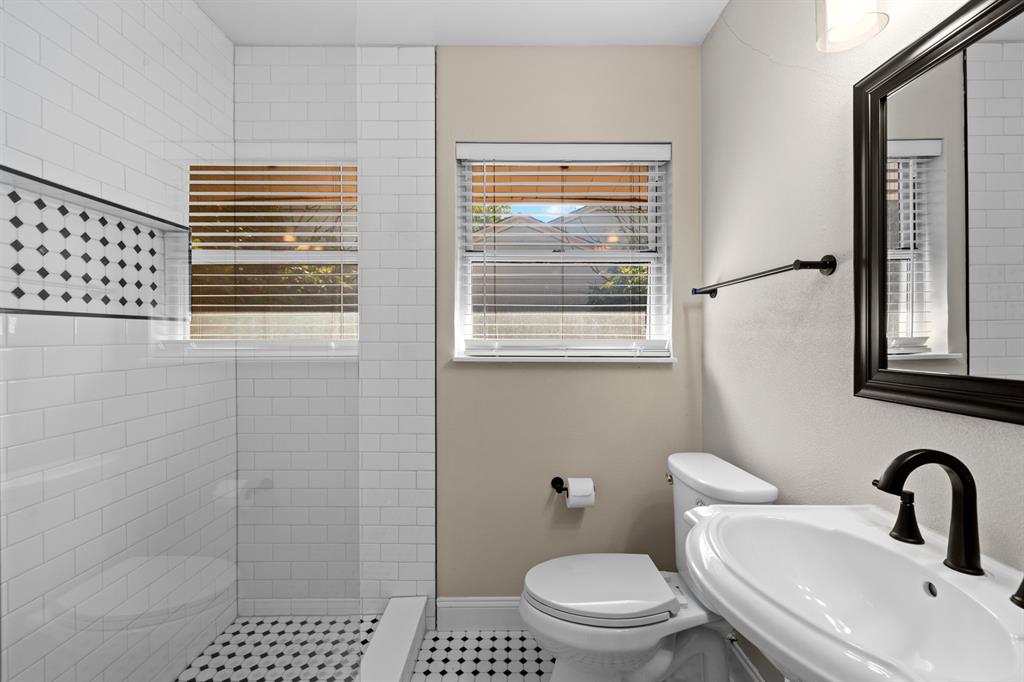 6317 Ravendale Lane Dallas, TX 75214 - Photo 11 of 16 a bathroom with a toilet a sink and a shower