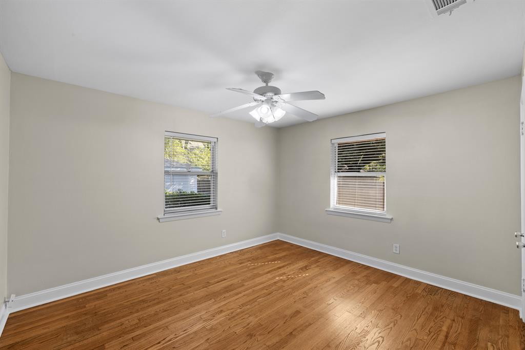 6317 Ravendale Lane Dallas, TX 75214 - Photo 12 of 16 a view of an empty room with a window and wooden floor