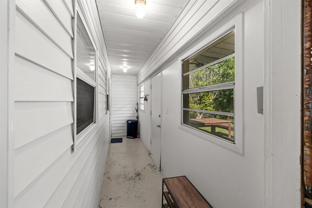 6317 Ravendale Lane Dallas, TX 75214 - Photo 13 of 16 a view of a hallway with wooden walls and windows