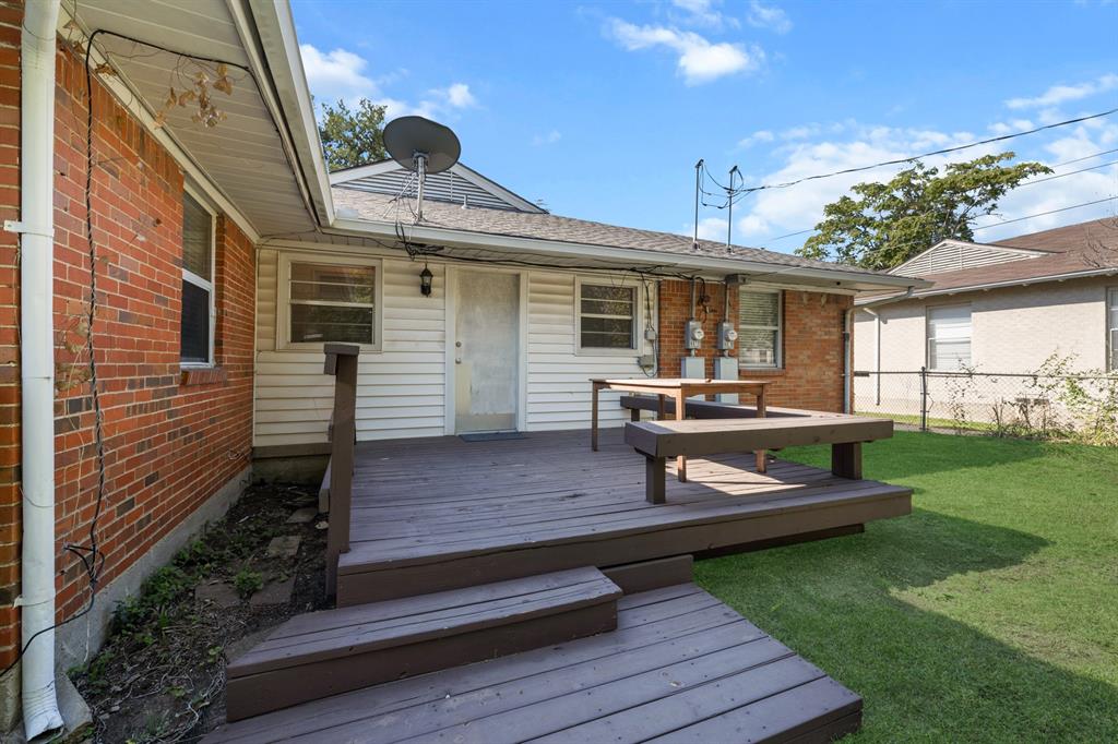 6317 Ravendale Lane Dallas, TX 75214 - Photo 15 of 16 a view of a house with wooden deck and a yard