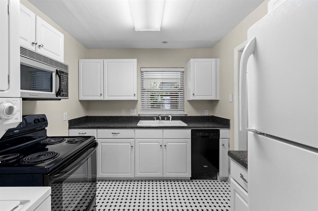 6317 Ravendale Lane Dallas, TX 75214 - Photo 8 of 16 a kitchen with granite countertop a stove sink and microwave