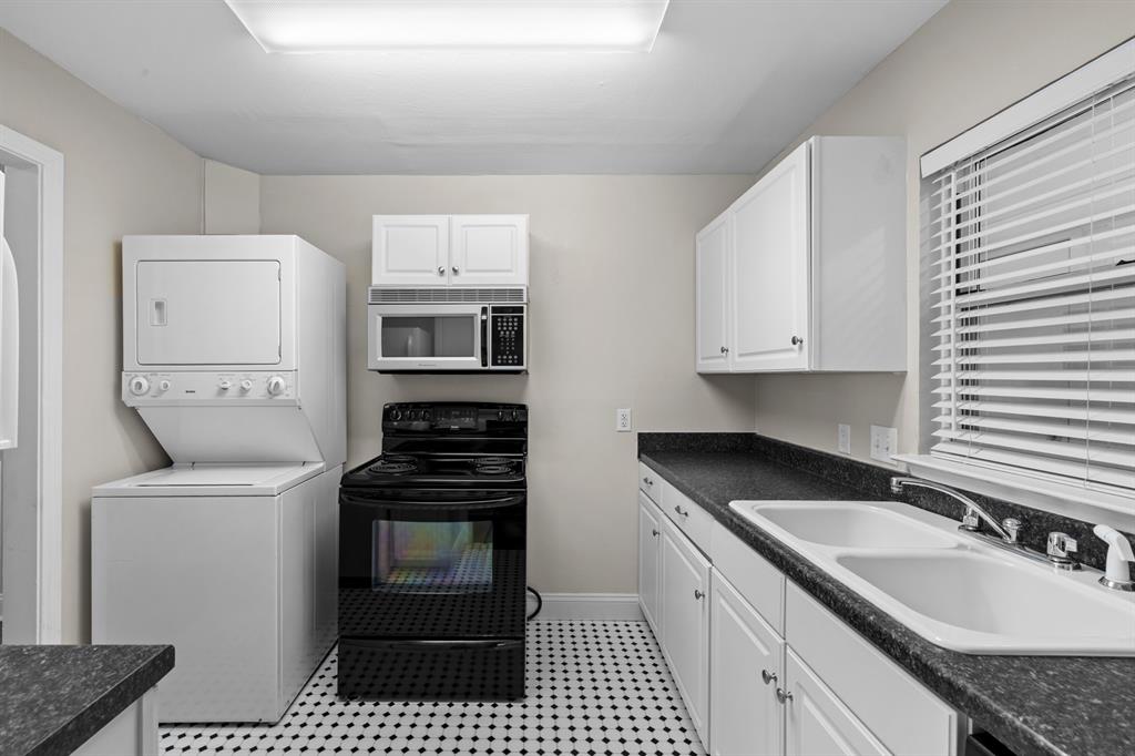 6317 Ravendale Lane Dallas, TX 75214 - Photo 9 of 16 a kitchen with a sink stove and cabinets