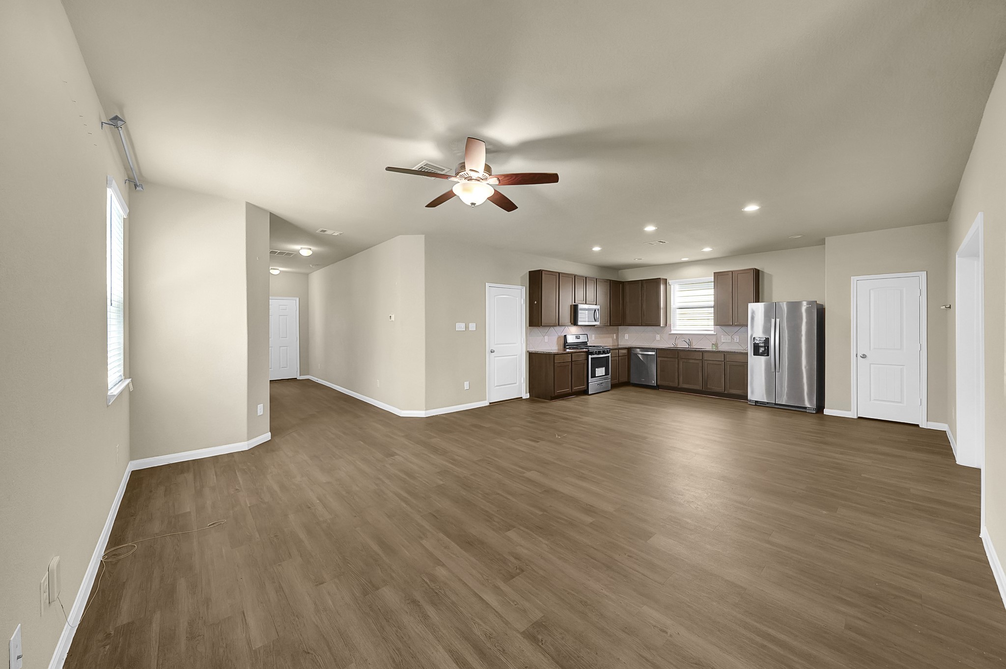 4274 McGregor Blf Lane Conroe, TX 77304 - Photo 3 of 25 a view of a kitchen with a stove cabinets and wooden floor