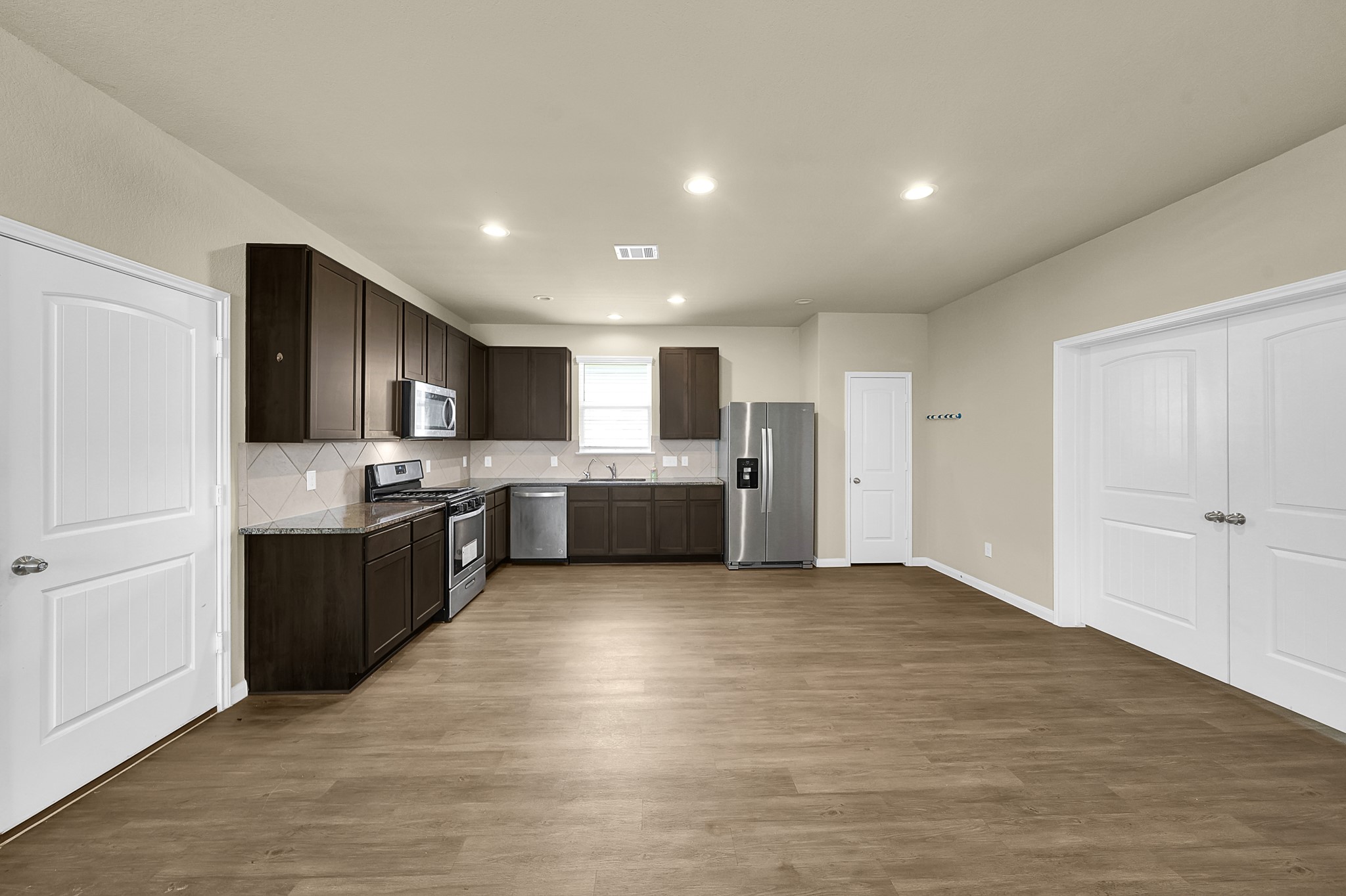 4274 McGregor Blf Lane Conroe, TX 77304 - Photo 7 of 25 a large kitchen with a large counter top space stainless steel appliances and cabinets