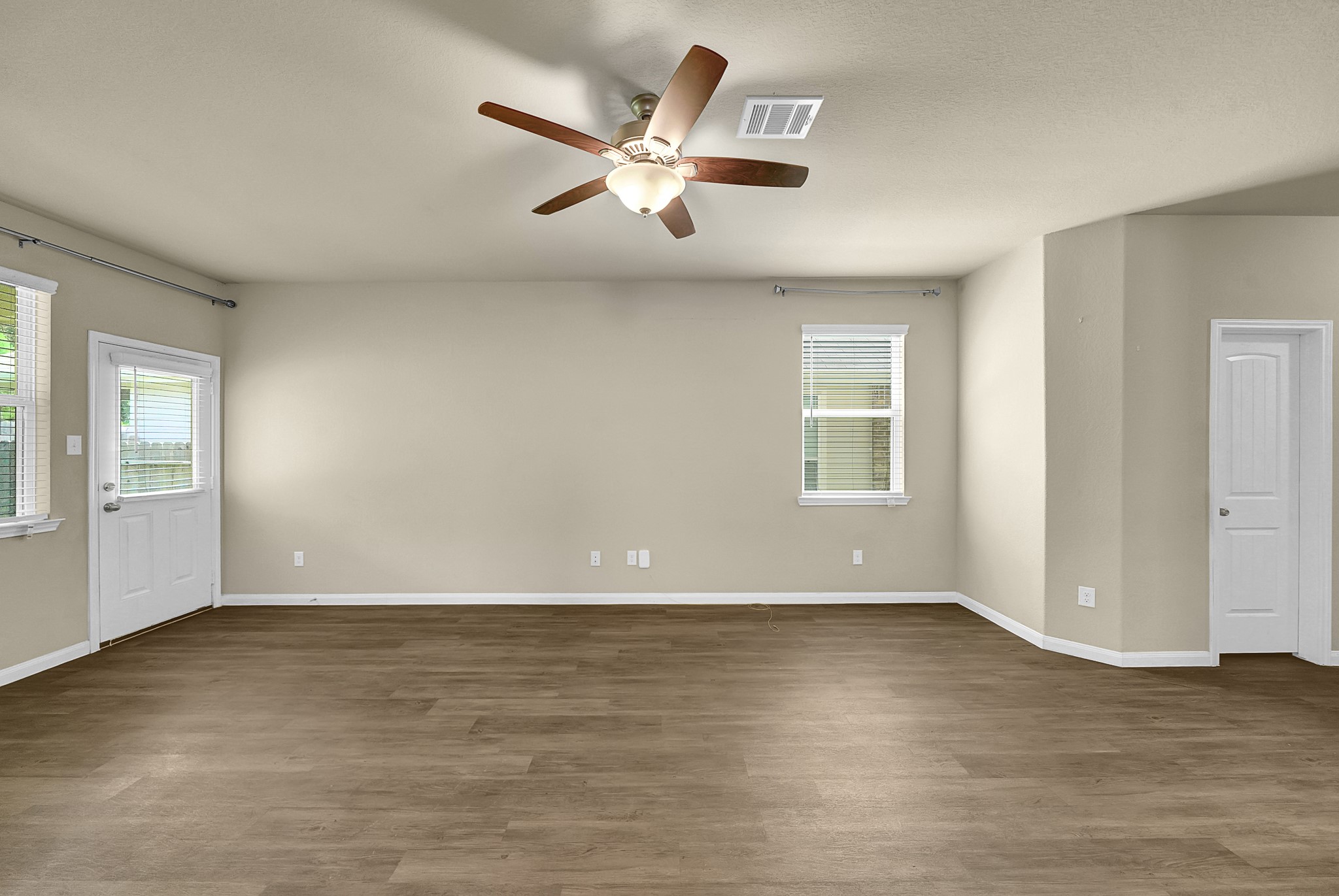 4274 McGregor Blf Lane Conroe, TX 77304 - Photo 9 of 25 a view of an empty room with wooden floor and a window
