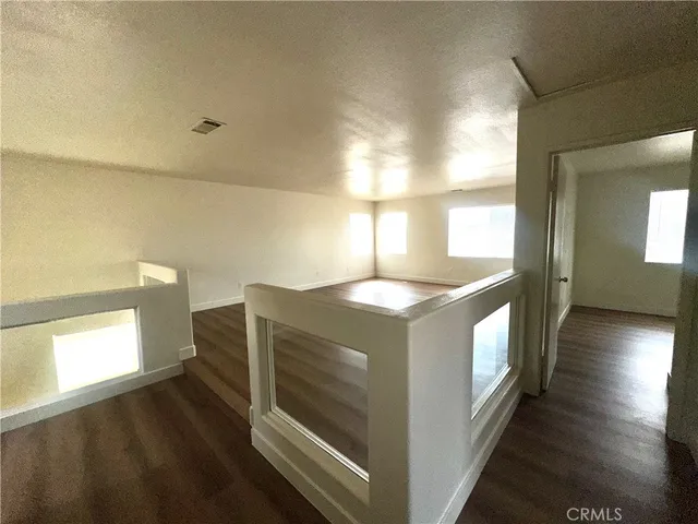 a view of kitchen and hall with wooden floor