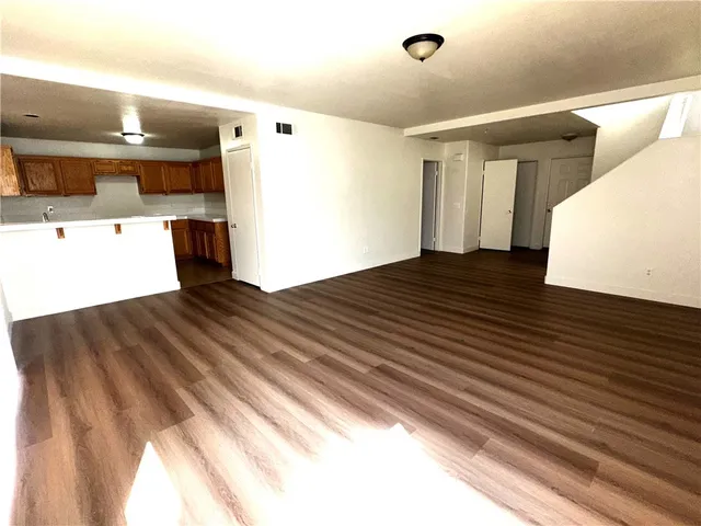 a view of a living room with wooden floor