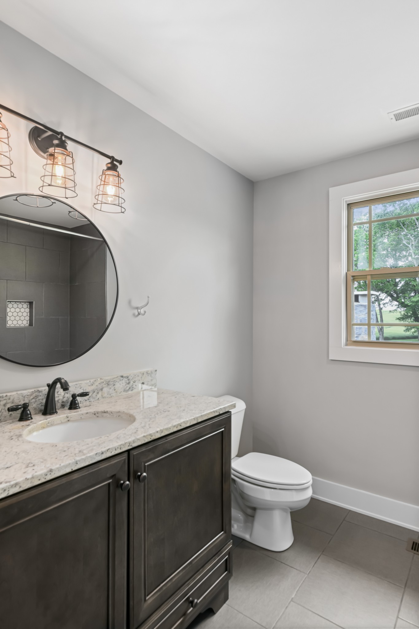 6557 Lamont Road Springfield, TN 37172 - Photo 28 of 62 a bathroom with a granite countertop toilet sink and mirror
