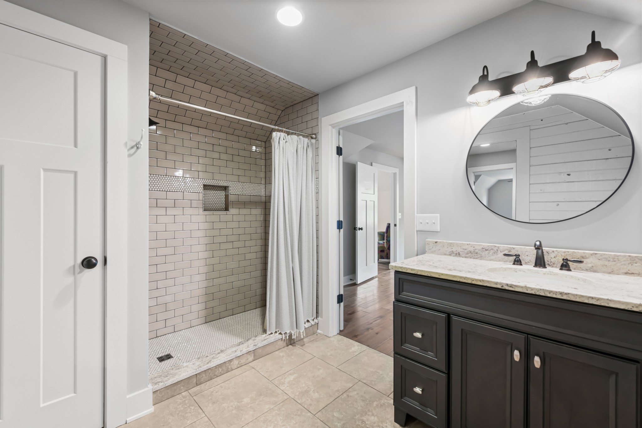 6557 Lamont Road Springfield, TN 37172 - Photo 32 of 62 a en suite bathroom with a double vanity sink mirror and shower