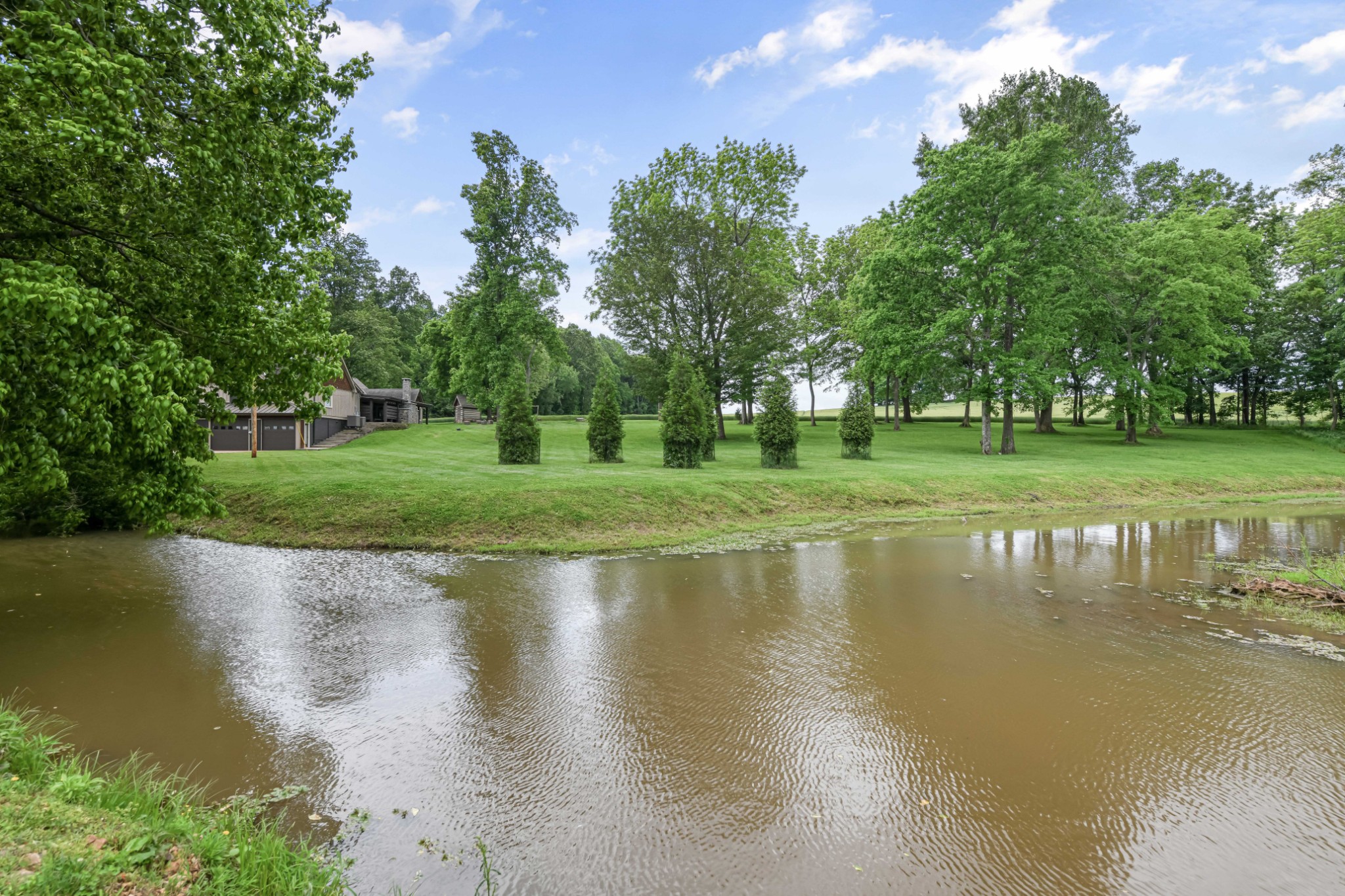 6557 Lamont Road Springfield, TN 37172 - Photo 57 of 62 a view of a lake with a large trees