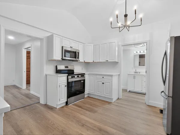 a kitchen with stainless steel appliances a refrigerator sink and microwave