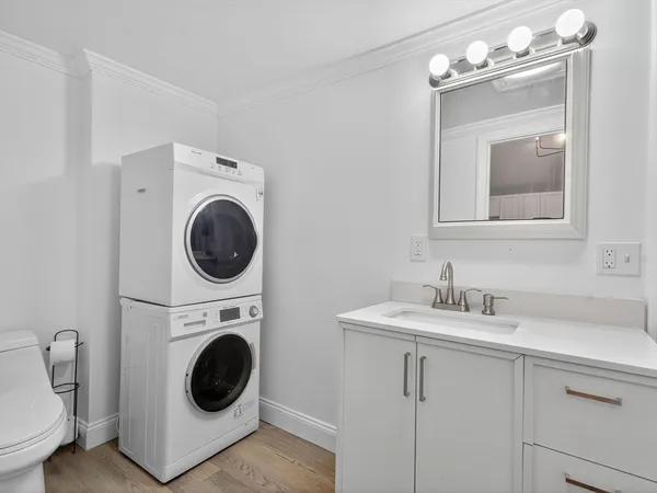a utility room with sink dryer and washer