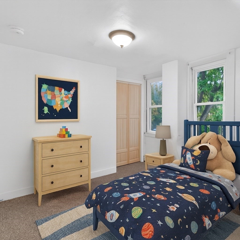 44 Liberty Street Randolph, MA 02368 - Photo 28 of 41 a bedroom with a bed and a flat tv screen