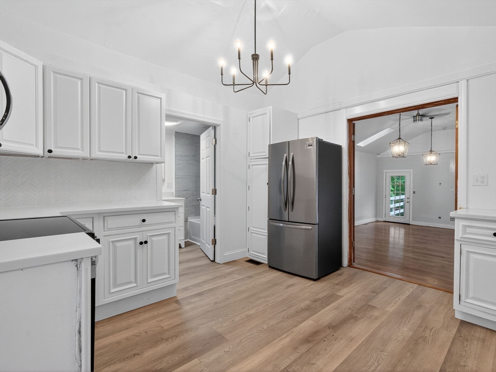 44 Liberty Street Randolph, MA 02368 - Photo 9 of 41 a kitchen with stainless steel appliances granite countertop a refrigerator a sink dishwasher a stove and white cabinets with wooden floor