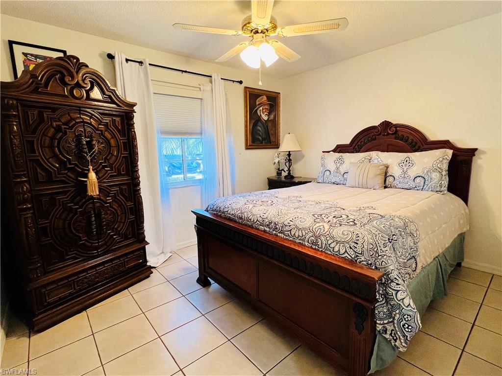 7719 Jewel Lane, Unit 103 Naples, FL 34109 - Photo 13 of 16 a bedroom with a bed and a walk in closet