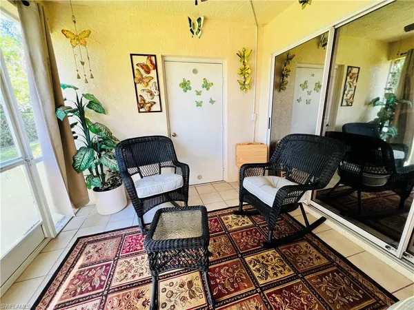 a living room with a rug and a window