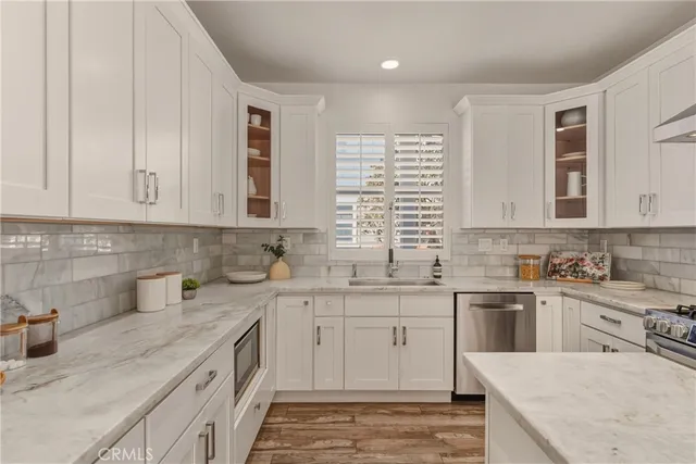 a kitchen with a sink stove and cabinets