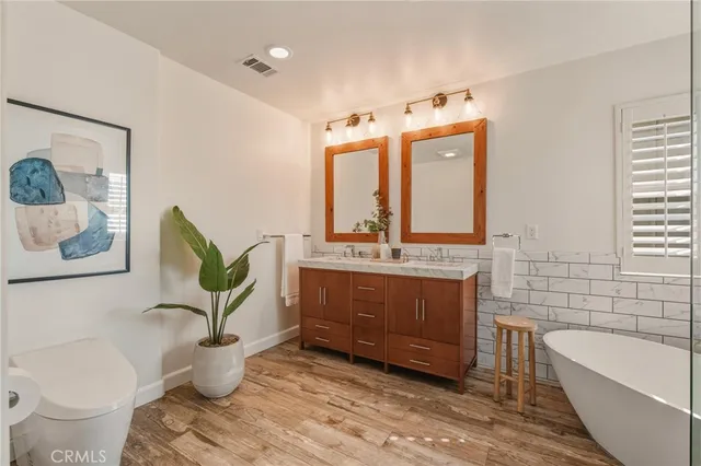 a bathroom with a bathtub sink and toilet