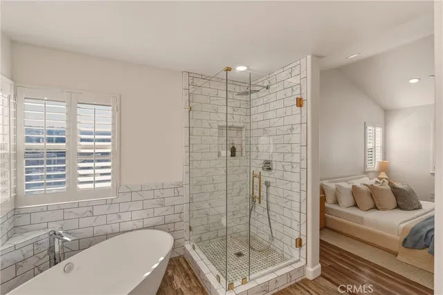 a bathroom with a shower a sink and a mirror