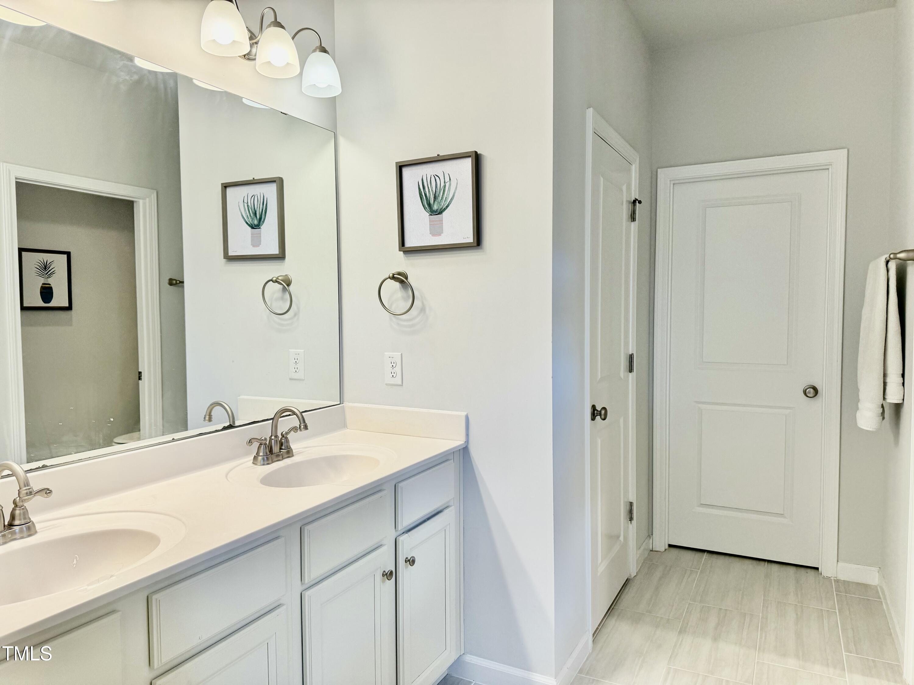 8600 Deep Elm Drive Wake Forest, NC 27587 - Photo 16 of 21 a bathroom with a sink and a mirror