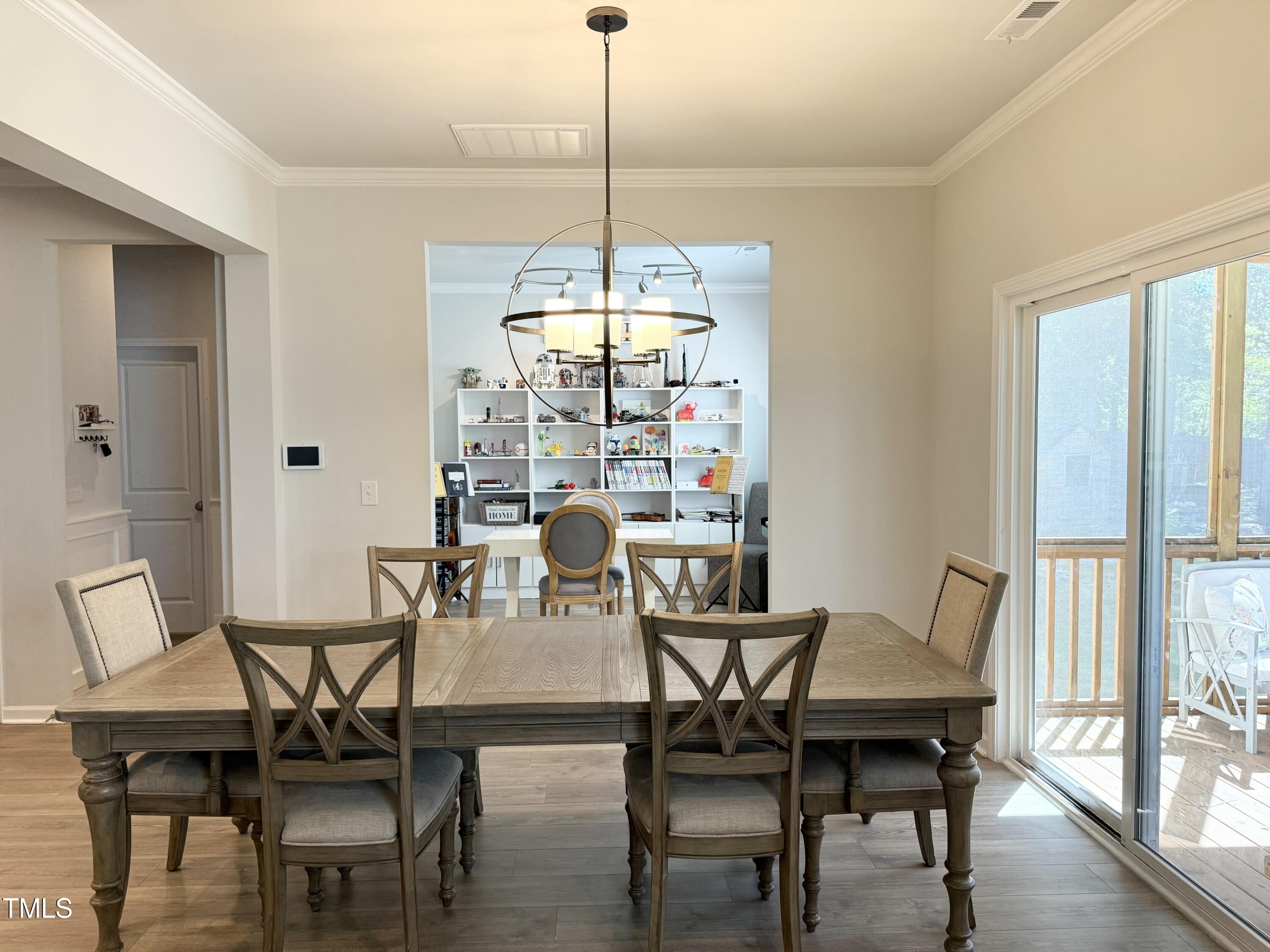 8600 Deep Elm Drive Wake Forest, NC 27587 - Photo 5 of 21 a dining room with furniture a chandelier and wooden floor