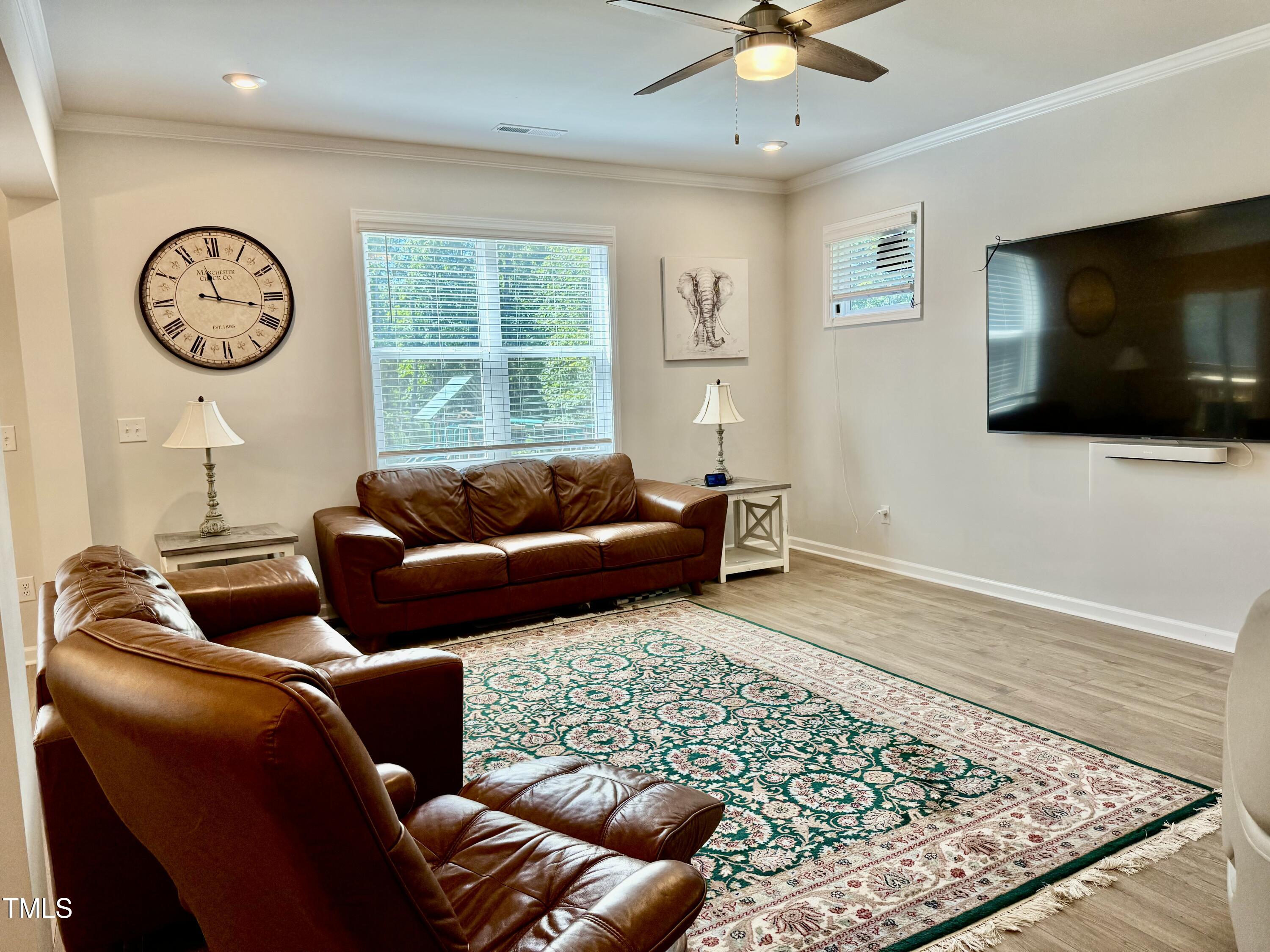 8600 Deep Elm Drive Wake Forest, NC 27587 - Photo 8 of 21 a living room with furniture a flat screen tv and a window