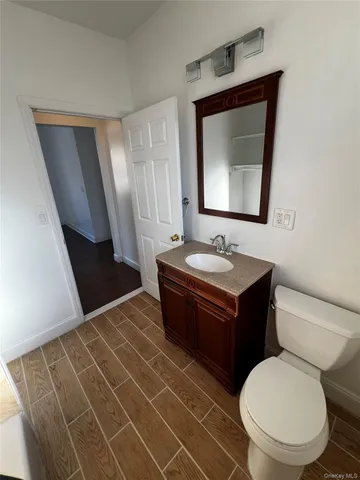 a bathroom with a sink toilet and mirror