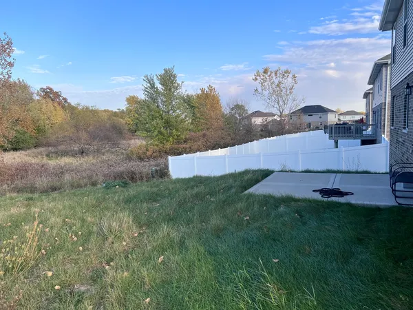 a view of wooden fence and a yard